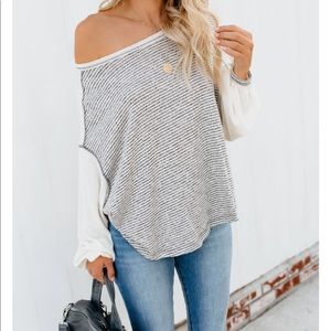 Off the shoulder grey and white shirt.